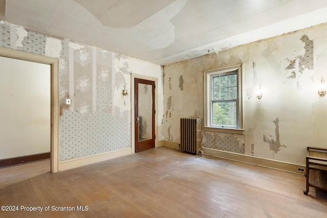 misc room with radiator heating unit and hardwood / wood-style floors