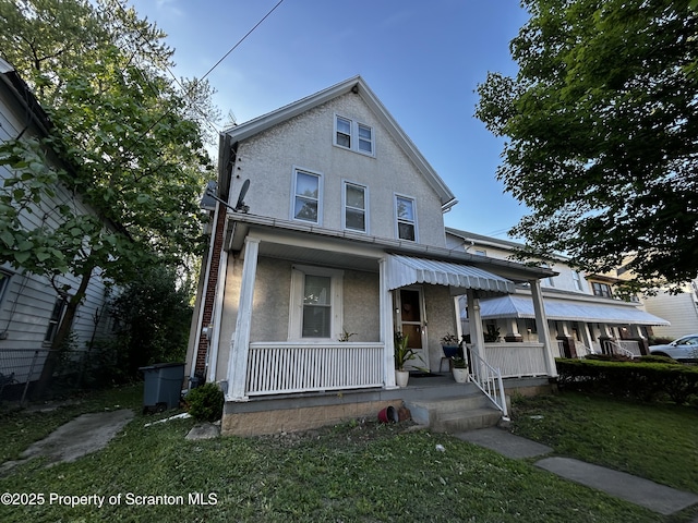 1423 Penn Ave, Scranton, PA 18509 - view of front of house with covered porch, stucco siding, and a front lawn