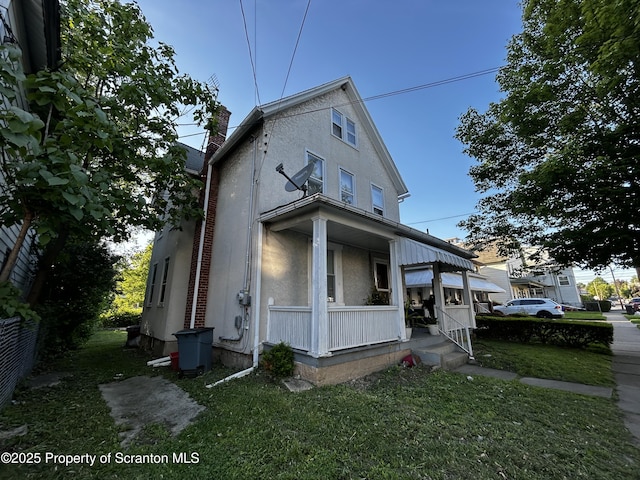 1423 Penn Ave, Scranton, PA 18509 - view of front of home featuring a porch, a chimney, and stucco siding