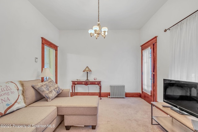 carpeted living room featuring a chandelier and radiator