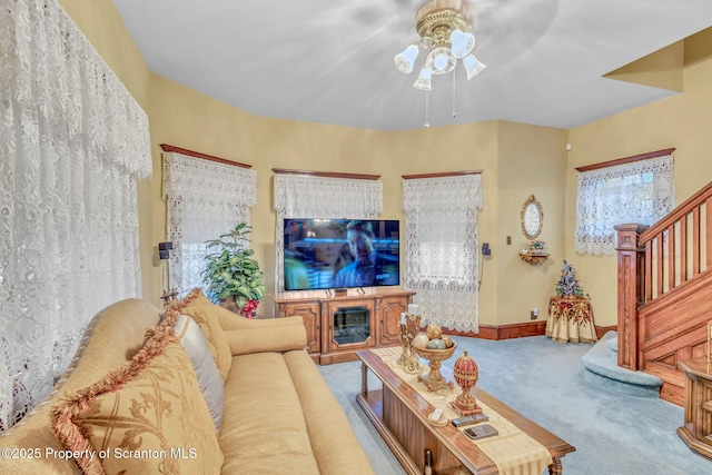 living room with ceiling fan and carpet