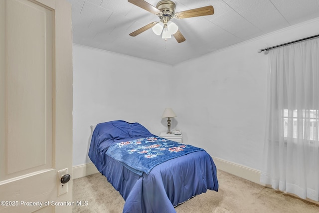 bedroom featuring light carpet, ceiling fan, and crown molding