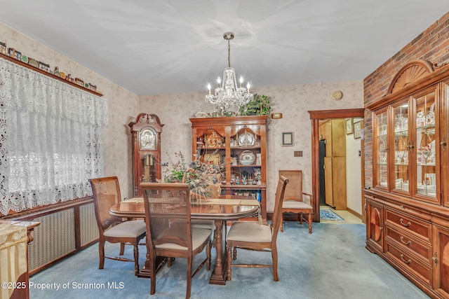 carpeted dining area with an inviting chandelier