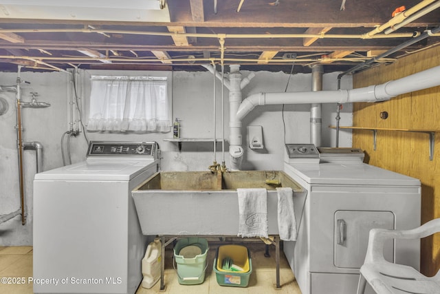 clothes washing area with sink and washer and clothes dryer