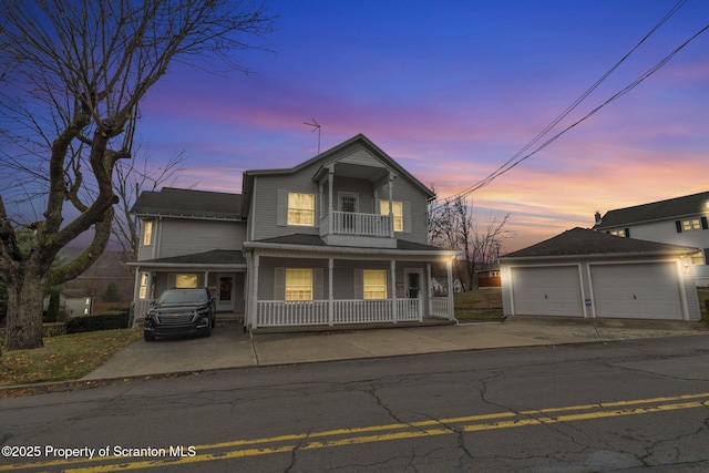 front facade featuring a porch, a balcony, and a garage