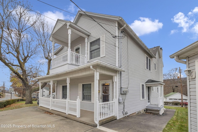 view of front of home with a balcony and a porch