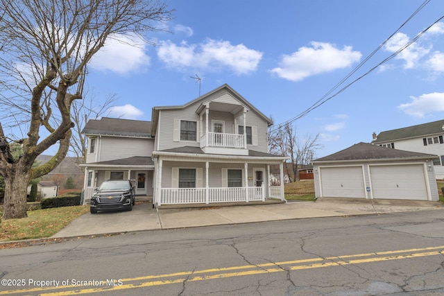 view of property with covered porch, a balcony, and a garage