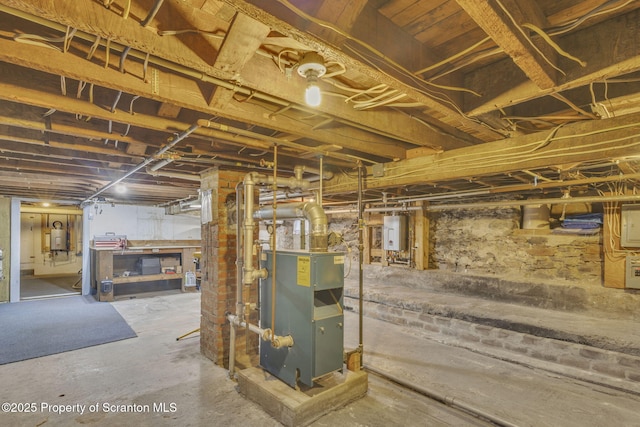 basement with water heater and tankless water heater