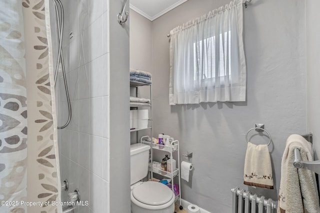 bathroom featuring toilet, a shower, ornamental molding, and radiator heating unit