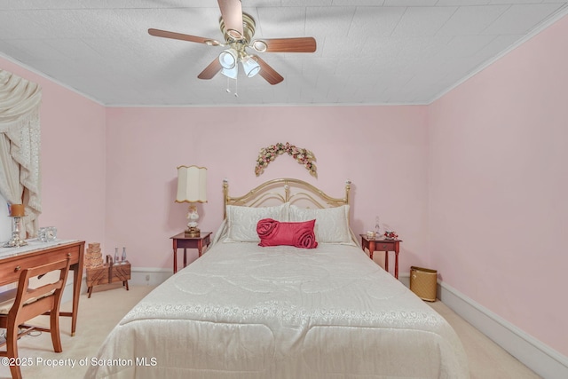 bedroom with ceiling fan, crown molding, and light carpet