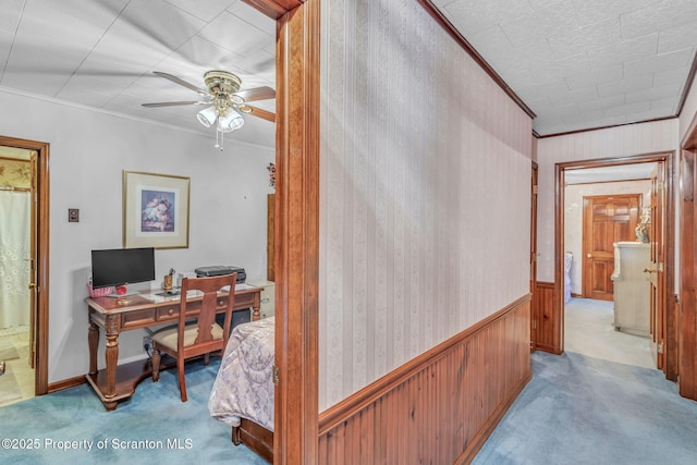 office area with ceiling fan, crown molding, and light carpet