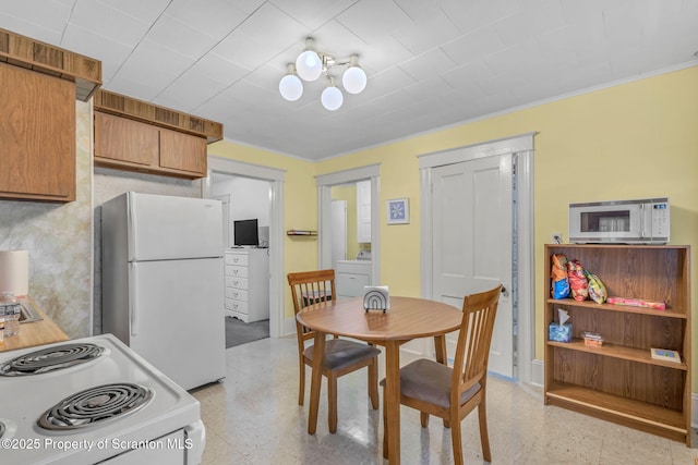 dining room with washer / dryer and crown molding