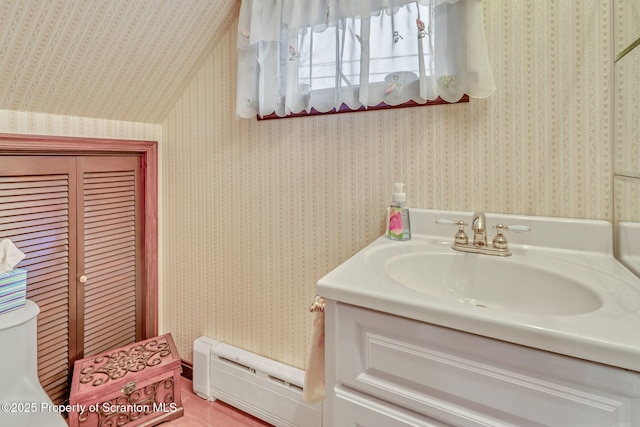 bathroom with toilet, baseboard heating, and vanity