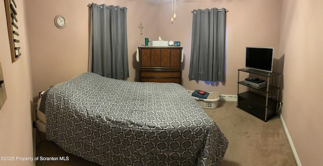 bedroom with baseboards, carpet floors, and baseboard heating