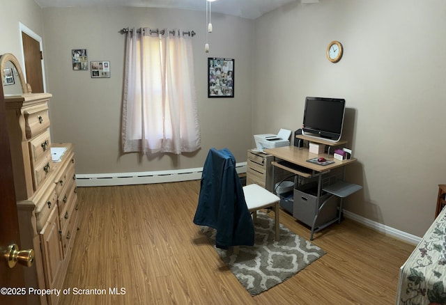 home office featuring wood finished floors and baseboards