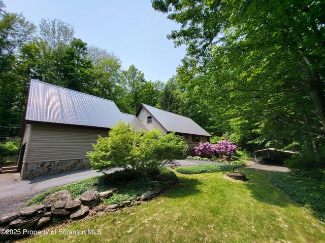 1445 Heart Lake Rd, Scott Twp, PA 18433 - view of property exterior featuring a metal roof, a detached carport, and a yard