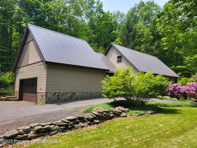 1445 Heart Lake Rd, Scott Twp, PA 18433 - view of home's exterior featuring a metal roof, a yard, an outbuilding, and stone siding