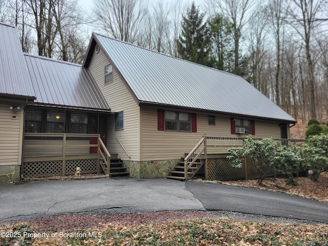 1445 Heart Lake Rd, Scott Twp, PA 18433 - rustic home with a metal roof, a sunroom, and stairs