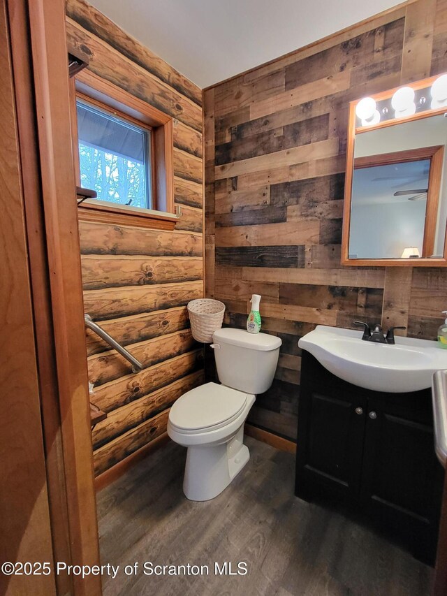 1445 Heart Lake Rd, Scott Twp, PA 18433 - bathroom with log walls, vanity, and wood finished floors