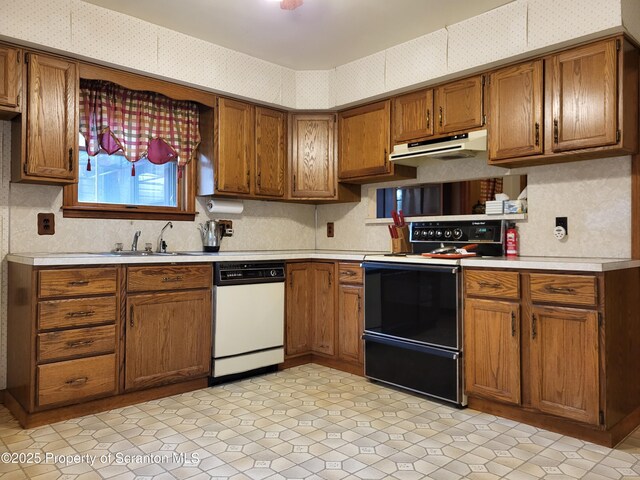 1445 Heart Lake Rd, Scott Twp, PA 18433 - kitchen with dishwasher, electric range, light countertops, brown cabinets, and wallpapered walls