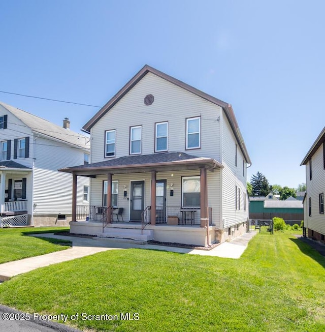view of front of property with a porch and a front lawn