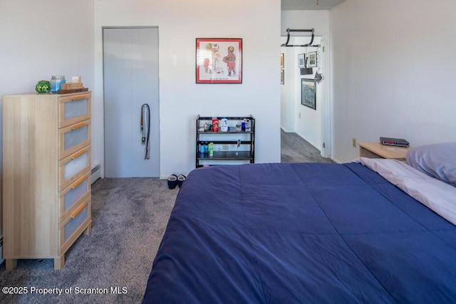 carpeted bedroom featuring a baseboard radiator