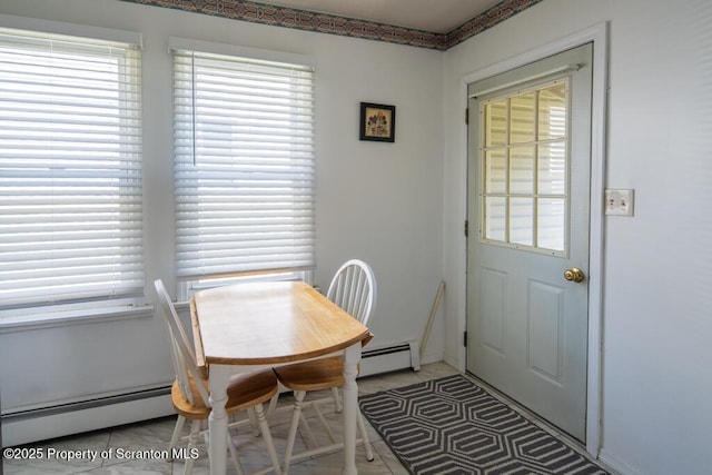 dining room featuring baseboard heating and healthy amount of natural light
