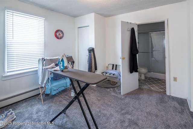 office space featuring carpet and a baseboard radiator