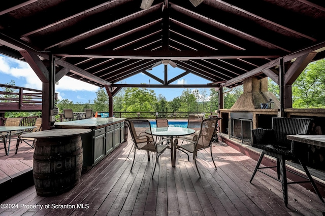 wooden terrace with a gazebo and exterior kitchen