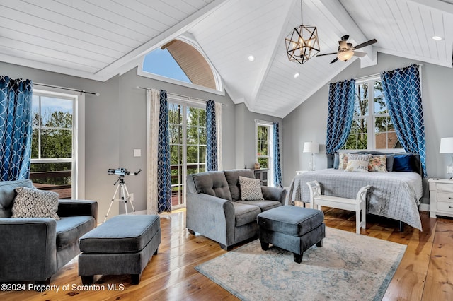 bedroom featuring vaulted ceiling with beams, light hardwood / wood-style floors, ceiling fan with notable chandelier, and access to exterior