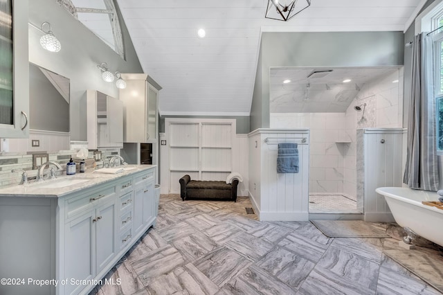 bathroom with vanity, separate shower and tub, and vaulted ceiling