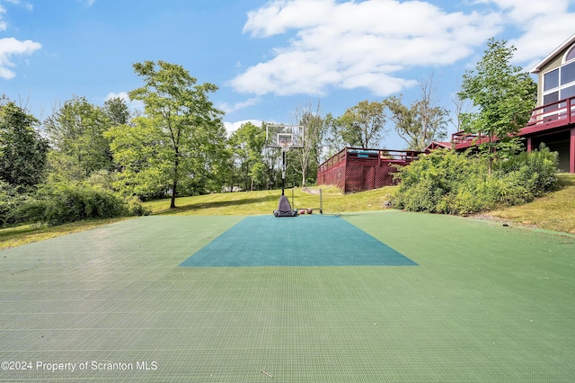 view of sport court featuring a lawn