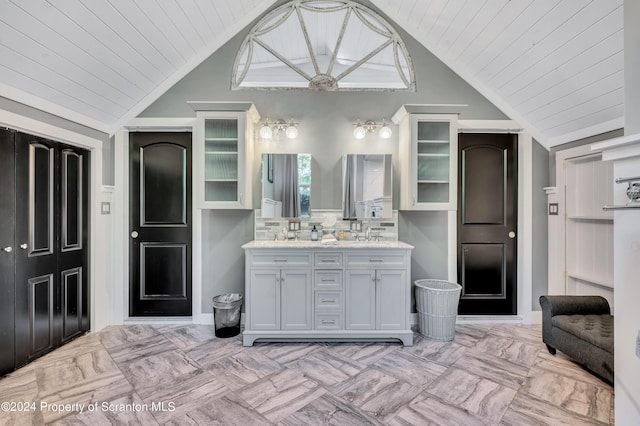 bathroom with decorative backsplash, wooden ceiling, vanity, and vaulted ceiling