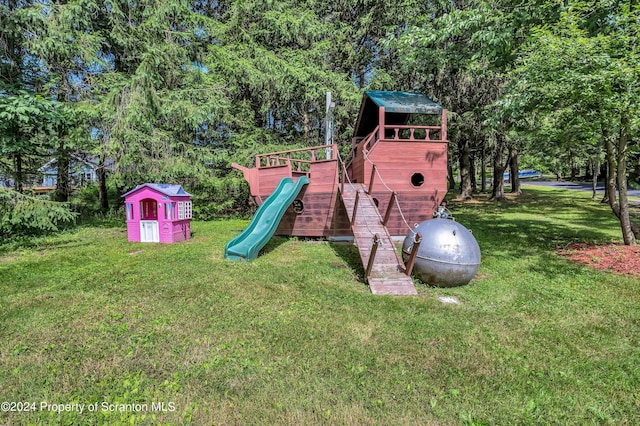 view of jungle gym featuring a lawn