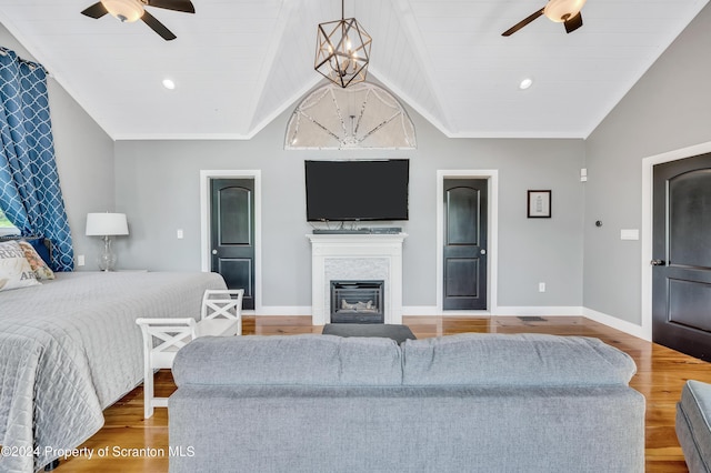 bedroom featuring ceiling fan with notable chandelier, light hardwood / wood-style floors, vaulted ceiling, and wood ceiling