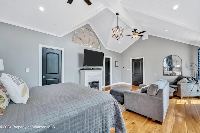 bedroom with lofted ceiling with beams, light hardwood / wood-style floors, wood ceiling, and ceiling fan with notable chandelier