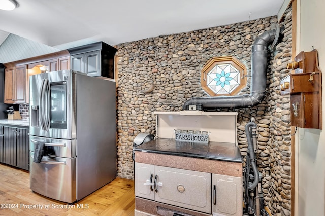 kitchen with light hardwood / wood-style floors and stainless steel refrigerator with ice dispenser