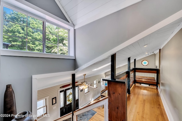 staircase featuring hardwood / wood-style floors, vaulted ceiling, and ceiling fan