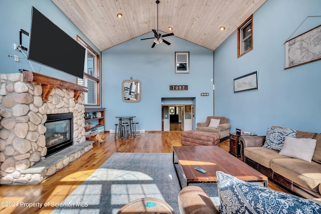 living room featuring a fireplace, hardwood / wood-style floors, ceiling fan, and wood ceiling