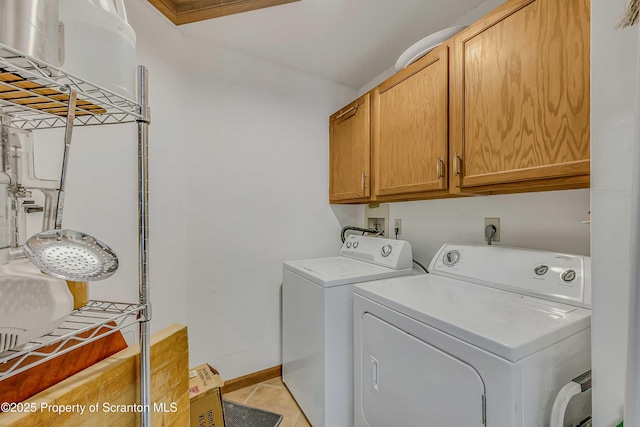 582 Lakeview Dr W, Lake Ariel, PA 18436 - washroom featuring cabinet space, separate washer and dryer, light tile patterned floors, and baseboards