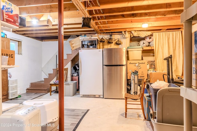 basement with stainless steel fridge