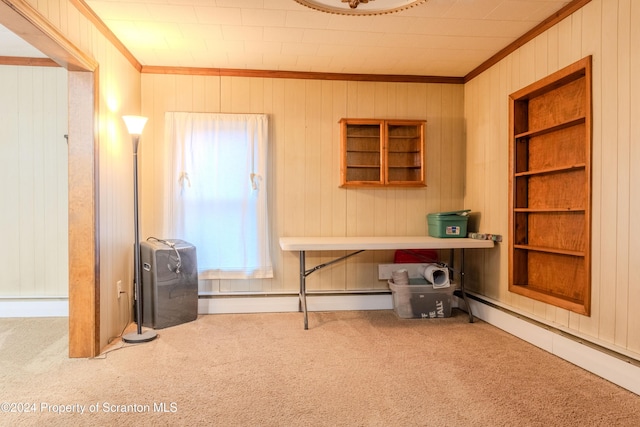 carpeted home office with built in features, ornamental molding, and wood walls