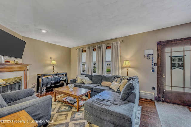 506 N Sumner Ave, Scranton, PA 18504 - living area with a baseboard heating unit, a glass covered fireplace, wood finished floors, and recessed lighting