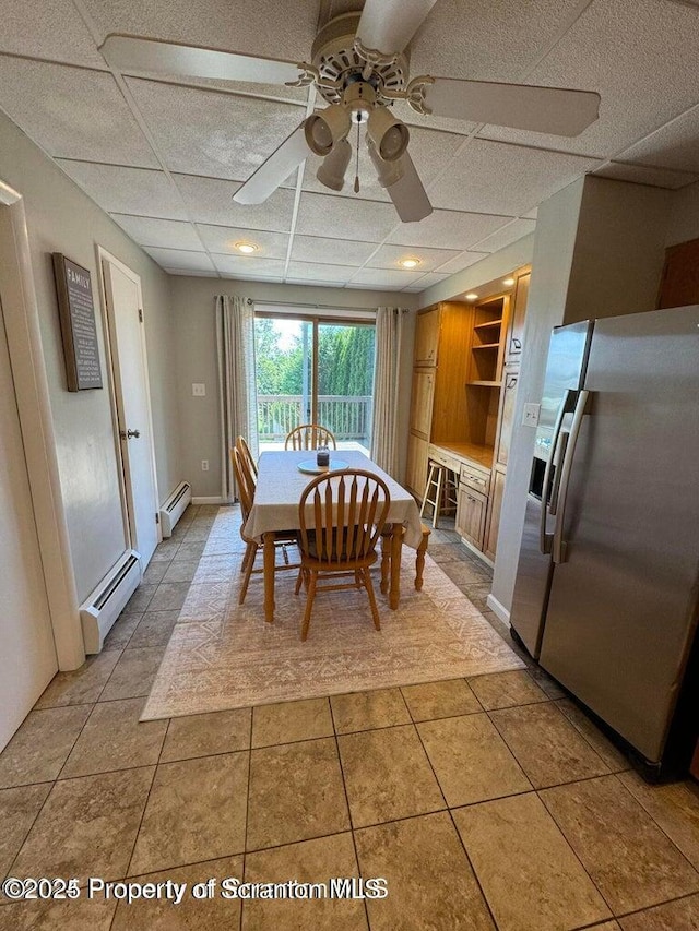 506 N Sumner Ave, Scranton, PA 18504 - dining space featuring baseboard heating, ceiling fan, a drop ceiling, and light tile patterned flooring