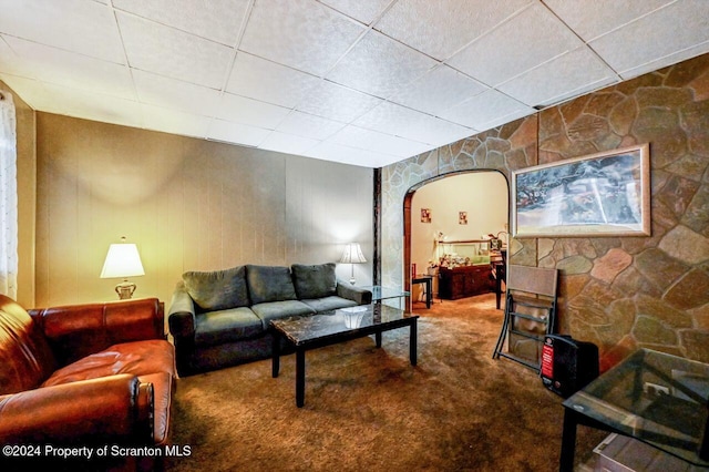 carpeted living room with a paneled ceiling