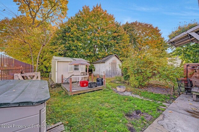 view of yard with a storage shed and a wooden deck