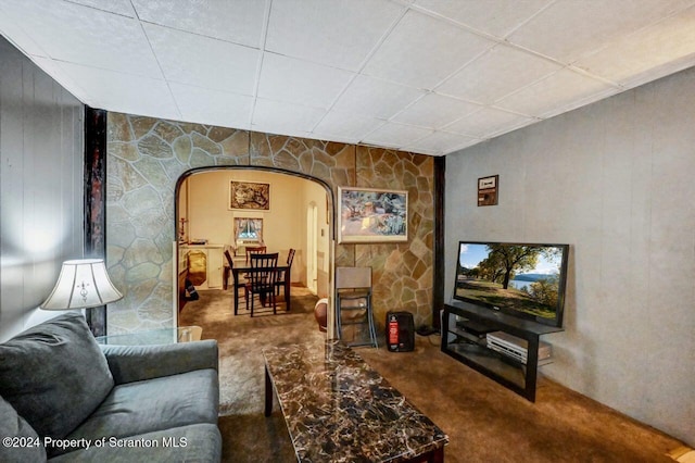 carpeted living room featuring a paneled ceiling