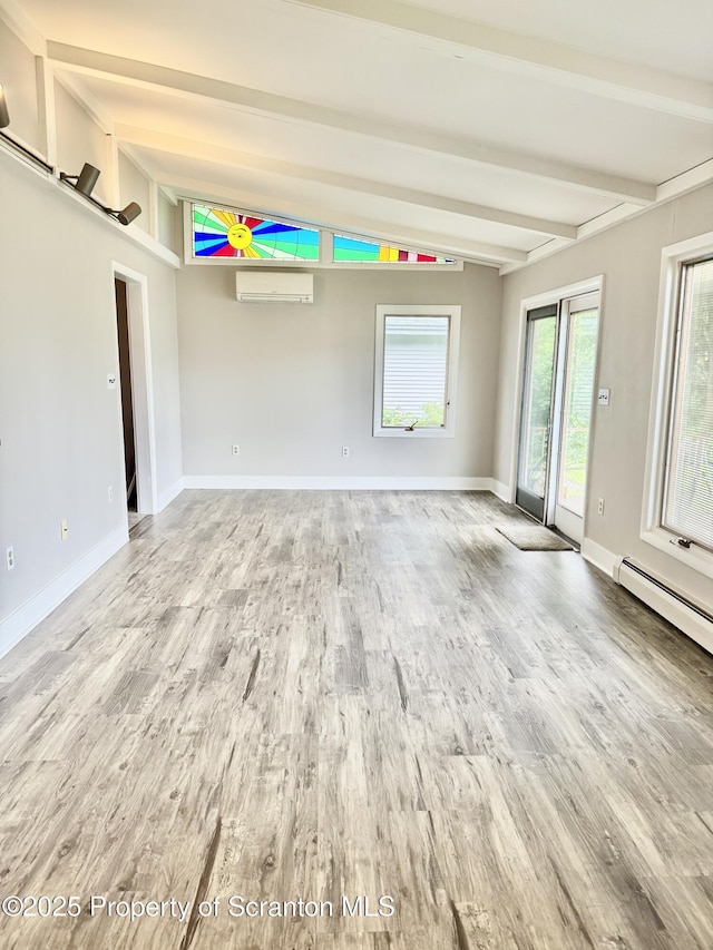 918 Hemlock St, Scranton, PA 18505 - empty room with a wall unit AC, wood finished floors, baseboards, and a baseboard heating unit