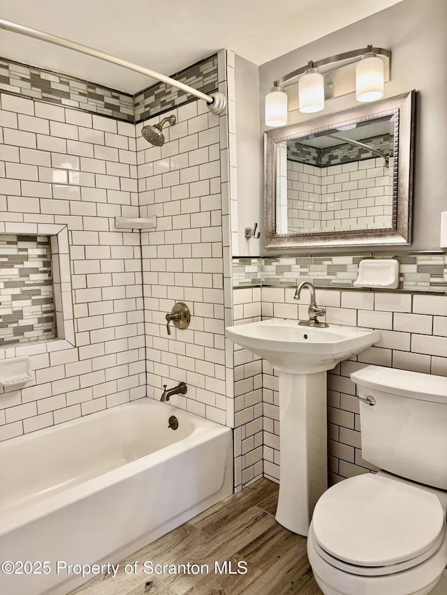 918 Hemlock St, Scranton, PA 18505 - full bath with wood finished floors, toilet,  shower combination, and tile walls