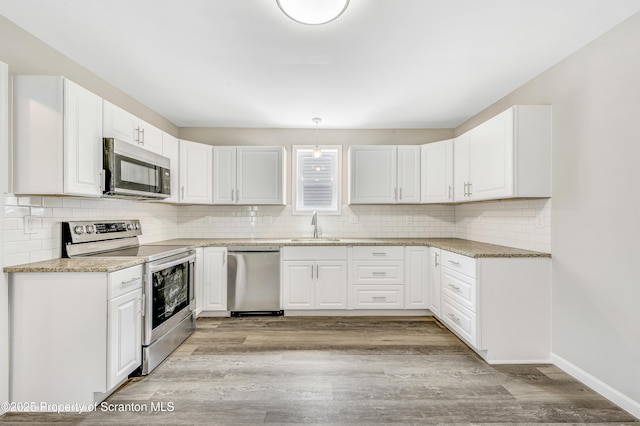 14 Maiden Ln, Susquehanna, PA 18847 - kitchen with stainless steel appliances, a sink, decorative backsplash, and light stone counters